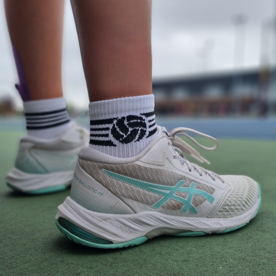 Netballer standing on side of court wearing Shoot netball socks